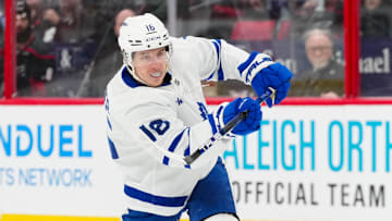 Jan 9, 2025; Raleigh, North Carolina, USA;  Toronto Maple Leafs right wing Mitch Marner (16) takes a shot against the Carolina Hurricanes during the second period at Lenovo Center. Mandatory Credit: James Guillory-Imagn Images