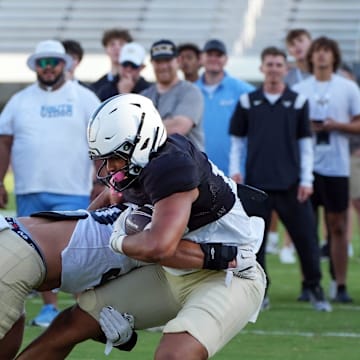 UCF wide receiver Waden Charles battles with Kam Moore during UCF Spring football practice at FBC Mortgage Stadium in Orlando, Friday, April 11, 2025.