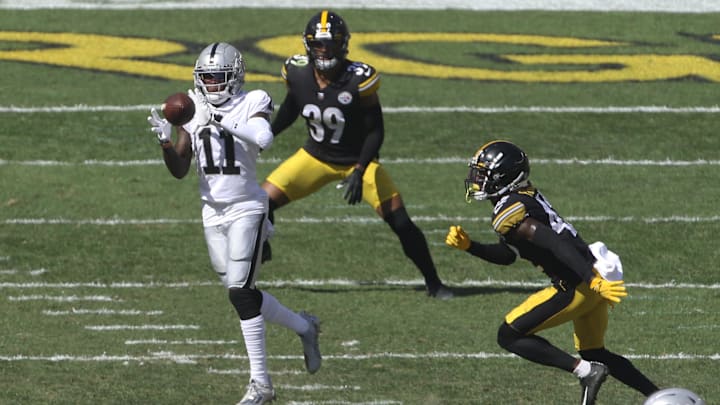 Sep 19, 2021; Pittsburgh, Pennsylvania, USA;  Las Vegas Raiders wide receiver Henry Ruggs III (11) makes a catch against Pittsburgh Steelers cornerback James Pierre (42) and free safety Minkah Fitzpatrick (39) during the third quarter at Heinz Field. Las Vegas won 26-17. Mandatory Credit: Charles LeClaire-Imagn Images
