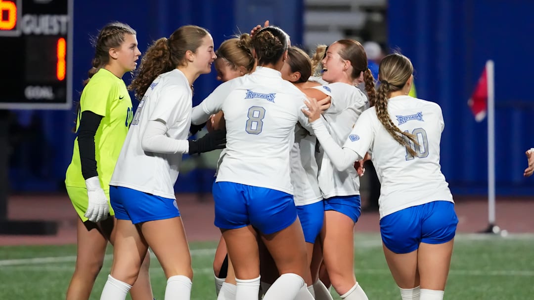 Hamilton Southeastern players celebrate the game's only goal during their 1-0 victory over Carmel in the 3A state final. The Royals finished the year undefeated at 22-0-1.