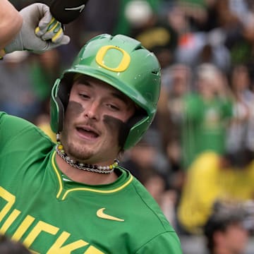Oregon outfielder Mason Neville, right, celebrates a home run with teammate Drew Smith as the Oregon Ducks host the Oregon State Beavers on April 25, 2025, at PK Park in Eugene.
