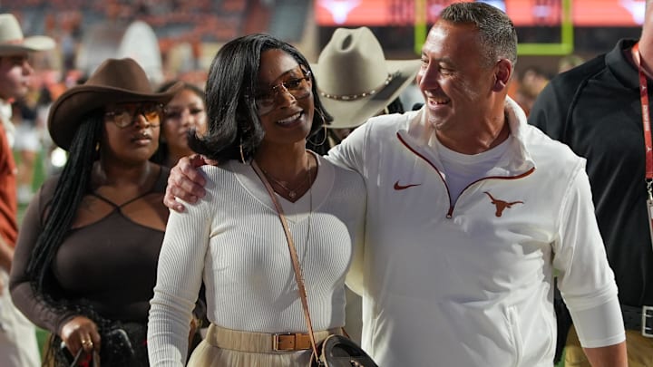 Texas Longhorns head coach Steve Sarkisian and his wife Loreal Sarkisian walk off the field after defeating the Kentucky Wildcats.