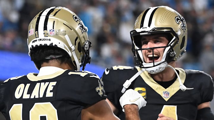 Sep 18, 2023; Charlotte, North Carolina, USA; New Orleans Saints quarterback Derek Carr (4) reacts with wide receiver Chris Olave (12) in the fourth quarter at Bank of America Stadium. 