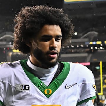 Nov 8, 2025; Iowa City, Iowa, USA; Oregon Ducks quarterback Dante Moore (5) runs off the field after the game against the Iowa Hawkeyes at Kinnick Stadium. Mandatory Credit: Jeffrey Becker-Imagn Images