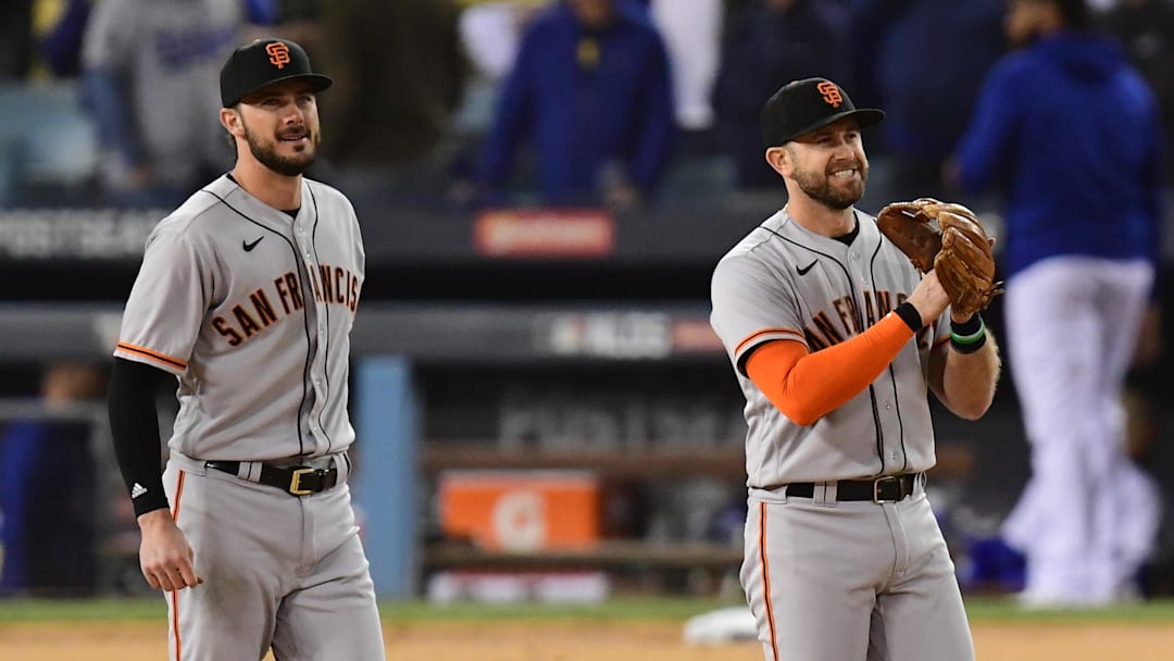 Oct 11, 2021; Los Angeles, California, USA; San Francisco Giants third baseman Evan Longoria (10) and first baseman Kris Bryant (23) celebrate after defeating the Los Angeles Dodgers in game three of the 2021 NLDS at Dodger Stadium. Mandatory Credit: Gary A. Vasquez-Imagn Images