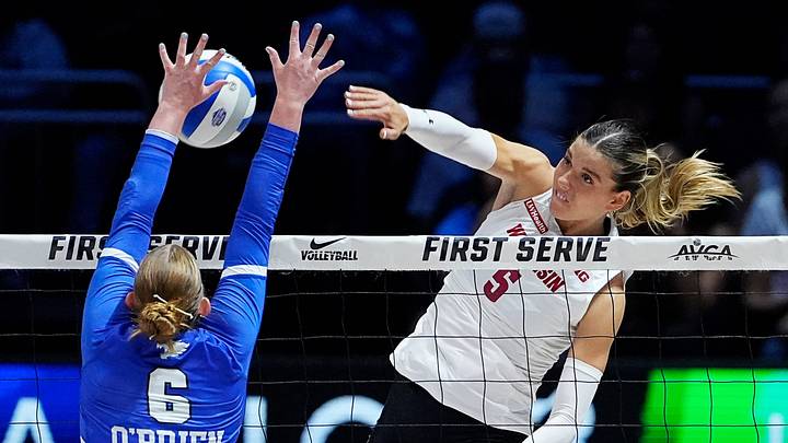 Kentucky Wildcats setter Kassie O'Brien (6) blocks the attack from Wisconsin Badgers outside hitter Eva Travis (5) during the third set of their match at the AVCA First Serve event at Fiserv Forum in Milwaukee, Wisconsin on Aug. 21, 2026.