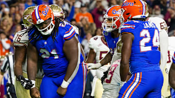 Florida Gators defensive lineman Desmond Watson (21) celebrates his sack of Florida State Seminoles quarterback Tate Rodemaker (18) at Steve Spurrier Field at Ben Hill Griffin Stadium in Gainesville, FL on Saturday, November 25, 2023 during the second half. Florida State won 24-15. [Doug Engle/Gainesville Sun]