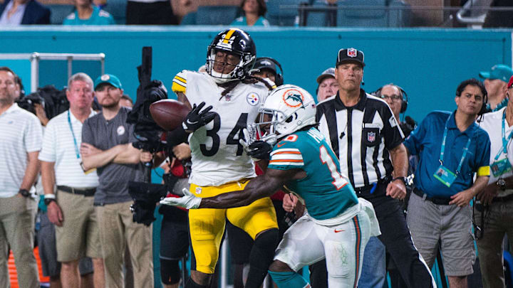 Miami Dolphins wide receiver Tyreek Hill attempts to make a reception under pressure from Pittsburgh Steelers safety Terrell Edmunds during the game between the visiting Pittsburgh Steelers and host Miami Dolphins.