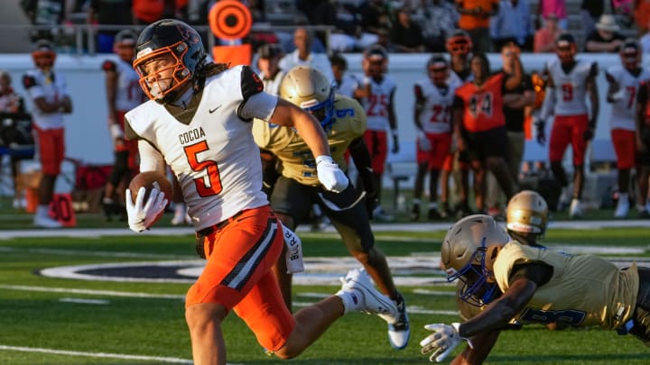 Cocoa's Jayvan Boggs escape tacklers to run for a touchdown during a game with Mainland at Daytona Stadium in Daytona Beach, Friday, Aug. 30, 2024.