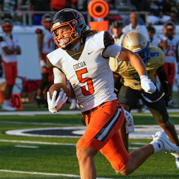 Cocoa's Jayvan Boggs escape tacklers to run for a touchdown during a game with Mainland at Daytona Stadium in Daytona Beach, Friday, Aug. 30, 2024.