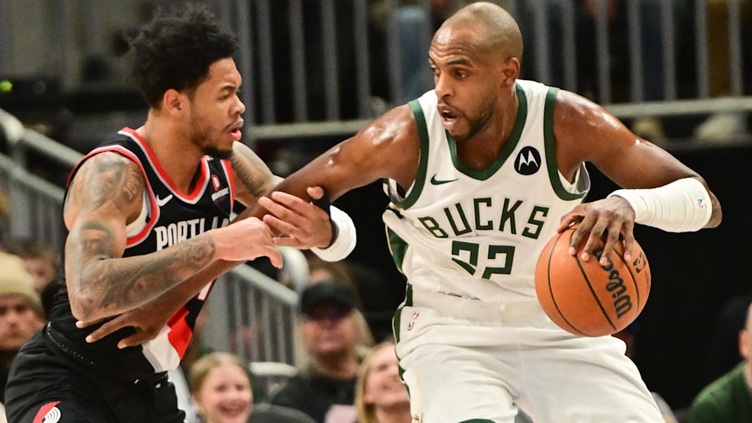 Jan 4, 2025; Milwaukee, Wisconsin, USA; Milwaukee Bucks forward Khris Middleton (22) is guarded by Portland Trail Blazers guard Anfernee Simons (1) in he first quarter at Fiserv Forum. Mandatory Credit: Benny Sieu-Imagn Images