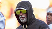 Nov 23, 2024; Kansas City, Missouri, USA;  Colorado head coach Deion Sanders watches his players warmup prior to the game between the Kansas Jayhawks and the Colorado Buffaloes at GEHA Field at Arrowhead Stadium. Mandatory Credit: Nick Tre. Smith-Imagn Images