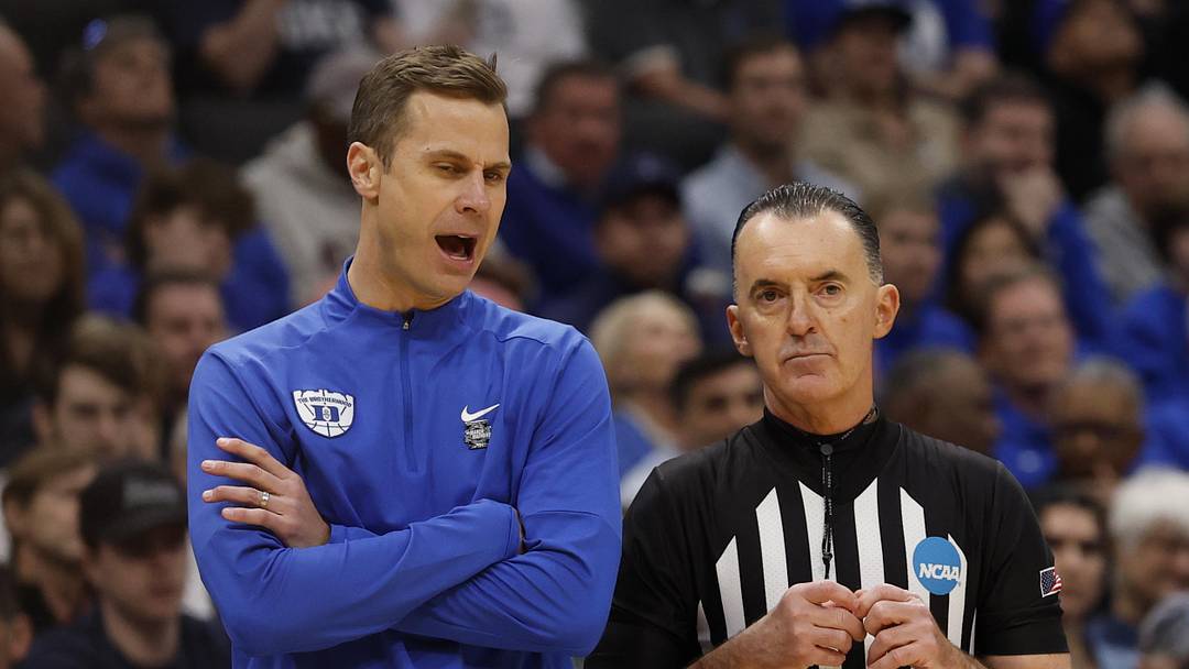 Mar 29, 2026; Washington, DC, USA; Duke Blue Devils head coach Jon Scheyer talks to a referee against the UConn Huskies in the first half during an Elite Eight game of the East Regional of the men's 2026 NCAA Tournament at Capital One Arena. Mandatory Credit: Geoff Burke-Imagn Images