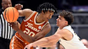 Texas guard Tre Johnson (20) keeps the ball away from Vanderbilt guard Chris Manon (30) during a NCAA college basketball first round game at the men’s Southeastern Conference Tournament Wednesday, March 12, 2025, in Nashville, Tenn.