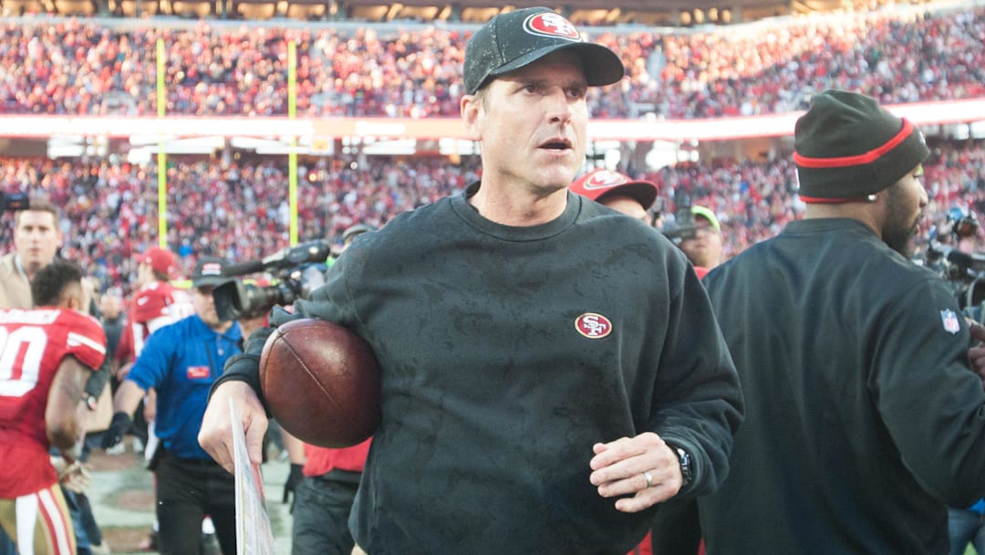 Dec 28, 2014; Santa Clara, CA, USA; San Francisco 49ers head coach Jim Harbaugh leaves the field after defeating the against the Arizona Cardinals 20-17 at Levi's Stadium. Mandatory Credit: Ed Szczepanski-Imagn Images