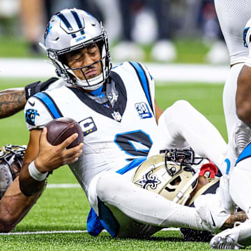 Sep 8, 2024; New Orleans, Louisiana, USA;  Carolina Panthers quarterback Bryce Young (9) is tackled as he scrambles out the pocket by New Orleans Saints cornerback Alontae Taylor (1) during the second half at Caesars Superdome. 