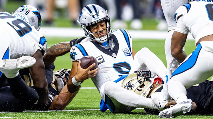 Sep 8, 2024; New Orleans, Louisiana, USA;  Carolina Panthers quarterback Bryce Young (9) is tackled as he scrambles out the pocket by New Orleans Saints cornerback Alontae Taylor (1) during the second half at Caesars Superdome. 