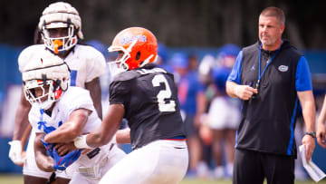 Florida Gators running back KD Daniels (21) tucks the ball after the hand off from Florida Gators quarterback DJ Lagway (2) during Fall practice at Sanders Practice Fields in Gainesville, FL on Tuesday, August 13, 2024. [Doug Engle/Gainesville Sun]