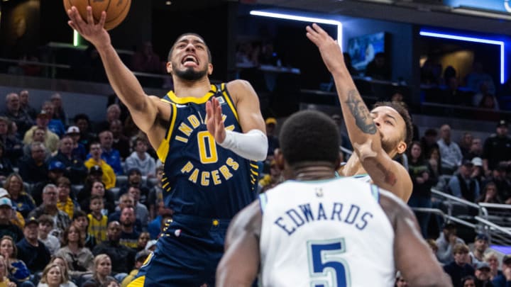 Mar 7, 2024; Indianapolis, Indiana, USA; Indiana Pacers guard Tyrese Haliburton (0) shoots the ball while Minnesota Timberwolves forward Kyle Anderson (1) defends during the second half at Gainbridge Fieldhouse. Mandatory Credit: Trevor Ruszkowski-USA TODAY Sports