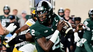 Oct 19, 2024; East Lansing, Michigan, USA;  Michigan State Spartans quarterback Aidan Chiles (2) scrambles against the Iowa Hawkeyes during the first quarter at Spartan Stadium. Mandatory Credit: Dale Young-Imagn Images