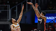 Oct 13, 2025; Atlanta, Georgia, USA; Miami Heat center Kel'El Ware (7) shoots the ball over Atlanta Hawks guard Caleb Houstan (33) during the first quarter at State Farm Arena. Mandatory Credit: Jordan Godfree-Imagn Images