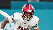Washington Commanders running back Chris Rodriguez Jr. carries the ball against the Miami Dolphins.