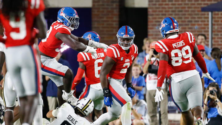 Oct 28, 2023; Oxford, Mississippi, USA; Mississippi Rebels defensive linemen Isaac Ukwu (99) and JJ Pegues (89) react with defensive linemen Cedric Johnson (2) after a defensive stop during the first half against the Vanderbilt Commodores at Vaught-Hemingway Stadium. Mandatory Credit: Petre Thomas-USA TODAY Sports