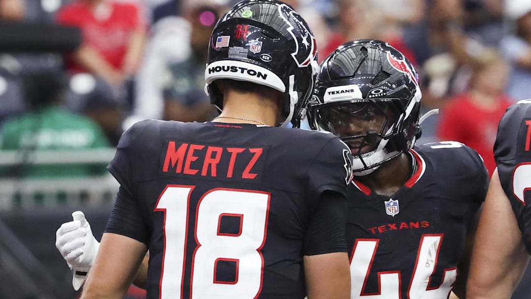 Houston Texans running back British Brooks (44) celebrates with quarterback Graham Mertz (18) after scoring a touchdown during the fourth quarter against the Carolina Panthers at NRG Stadium.