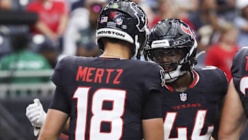 Houston Texans running back British Brooks (44) celebrates with quarterback Graham Mertz (18) after scoring a touchdown during the fourth quarter against the Carolina Panthers at NRG Stadium.