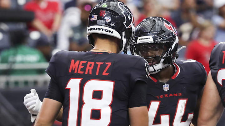 Houston Texans running back British Brooks (44) celebrates with quarterback Graham Mertz (18) after scoring a touchdown during the fourth quarter against the Carolina Panthers at NRG Stadium.
