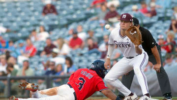 MIssissippi State's Hunter Hines (44) waits for the throw from the pitcher as Ole Miss' Andrew Fischer (3) is safe at first at Trustmark Park in Pearl, Miss., Wednesday, May 1, 2024.