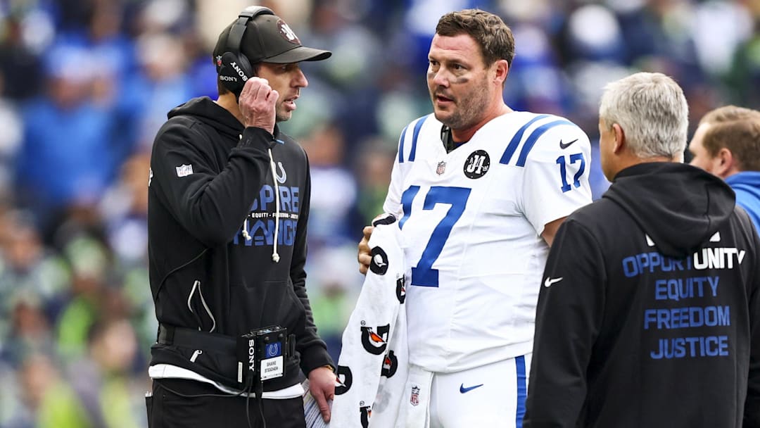 Dec 14, 2025; Seattle, Washington, USA; Indianapolis Colts head coach Shane Steichen, left, talks with quarterback Philip Rivers (17) during a second quarter timeout against the Seattle Seahawks at Lumen Field. 