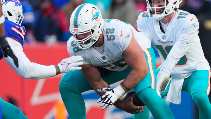 Jan 15, 2023; Orchard Park, New York, USA; Miami Dolphins guard Connor Williams (58) snaps the ball to Miami Dolphins quarterback Skylar Thompson (19) during a wild card game against the Buffalo Bills at Highmark Stadium. Mandatory Credit: Gregory Fisher-USA TODAY Sports