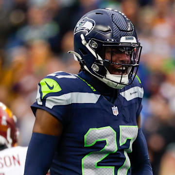 Nov 12, 2023; Seattle, Washington, USA; Seattle Seahawks cornerback Riq Woolen (27) reacts after a pass defense against the Washington Commanders during the second quarter at Lumen Field. 