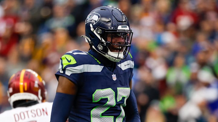 Nov 12, 2023; Seattle, Washington, USA; Seattle Seahawks cornerback Riq Woolen (27) reacts after a pass defense against the Washington Commanders during the second quarter at Lumen Field. 