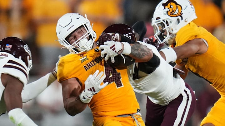 Arizona State running back Cam Skattebo (4) runs the ball as Mississippi State Bulldogs safety Isaac Smith (2) tries to tackle him at Mountain America Stadium in Tempe on Sept. 7, 2024.