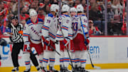 Apr 14, 2025; Sunrise, Florida, USA; New York Rangers center Juuso Parssinen (71) celebrates with teammates after scoring against the Florida Panthers during the second period at Amerant Bank Arena. Mandatory Credit: Sam Navarro-Imagn Images