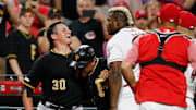 Pittsburgh Pirates relief pitcher Kyle Crick (30) and Cincinnati Reds right fielder Yasiel Puig (66) face off as the teams brawl in the ninth inning of the MLB National League game between the Cincinnati Reds and the Pittsburgh Pirates at Great American Ball Park in downtown Cincinnati on Tuesday, July 30, 2019. The Pirates won 11-4.

Pittsburgh Pirates At Cincinnati Reds