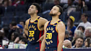 Jan 7, 2025; San Francisco, California, USA;  Golden State Warriors forward Trayce Jackson-Davis (32) and guard Stephen Curry (30) watch a reply during the fourth quarter against the Miami Heat at Chase Center. Mandatory Credit: John Hefti-Imagn Images