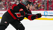 Feb 1, 2025; Raleigh, North Carolina, USA;  Carolina Hurricanes right wing Mikko Rantanen (96) takes a shot against the Los Angeles Kings during the third period at Lenovo Center. Mandatory Credit: James Guillory-Imagn Images