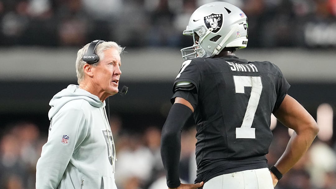 Nov 23, 2025; Paradise, Nevada, USA; Las Vegas Raiders quarterback Geno Smith (7) talks to head coach Pete Carroll in game against the Cleveland Browns during the fourth quarter at Allegiant Stadium. Mandatory Credit: Stephen R. Sylvanie-Imagn Images