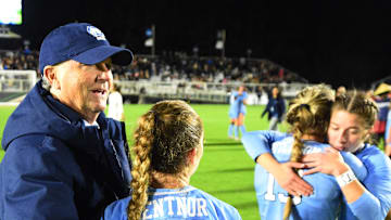 Dec 2, 2022; Cary, NC, USA; North Carolina Tar Heels  head coach Anson Dorrance hugs Ally Sentnor (21) after the game at WakeMed Soccer Park. Mandatory Credit: Bob Donnan-Imagn Images