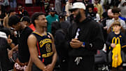 Mar 28, 2023; Houston, TX, USA; West guard Bronny James (6) with father LeBron James following the McDonald's All American Boy's high school basketball game at Toyota Center. Mandatory Credit: Mark J. Rebilas-Imagn Images
