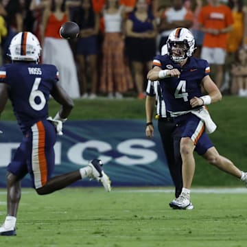 Sep 20, 2025; Charlottesville, Virginia, USA; Virginia Cavaliers quarterback Chandler Morris (4) passes the ball to Cavaliers wide receiver Cam Ross (6) as Stanford Cardinal linebacker Ese Dubre (30) chases during the second quarter at Scott Stadium. Mandatory Credit: Geoff Burke-Imagn Images