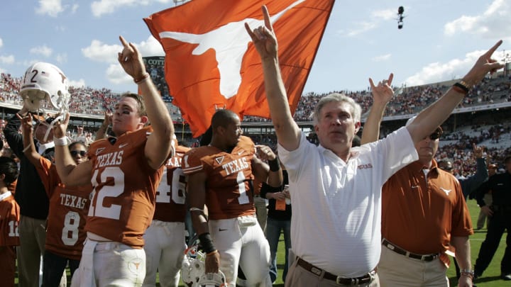 Oct 17, 2009; Dallas, TX, USA; Texas Longhorns quarterback Colt McCoy (12) and head coach Mack Brown celebrate a victory over the Oklahoma Sooners in the Red River Rivalry at the Cotton Bowl. Texas beat Oklahoma 16-13. Mandatory Credit: Tim Heitman-USA TODAY Sports