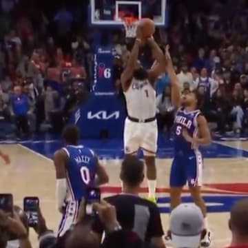 Two referees watch as Quentin Grimes hits James Harden’s elbow on a last-second shot in Philadelphia. 