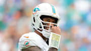 Oct 12, 2025; Miami Gardens, Florida, USA; Miami Dolphins quarterback Tua Tagovailoa (1) looks on from the field against the Los Angeles Chargers during the third quarter at Hard Rock Stadium. 