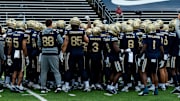 The Akron football team gathers before their 2025 season opener against Wyoming.