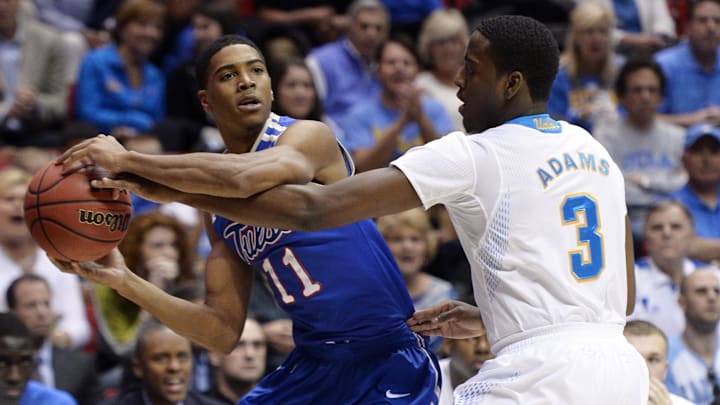 Mar 21, 2014; San Diego, CA, USA; Tulsa Golden Hurricane guard Shaquille Harrison (11) holds the ball away from UCLA Bruins guard Jordan Adams (3) in the first half of a men's college basketball game during the second round of the 2014 NCAA Tournament at Viejas Arena. Mandatory Credit: Robert Hanashiro-Imagn Images