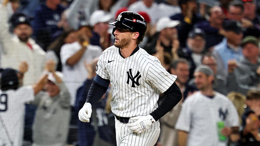 Oct 8, 2025; Bronx, New York, USA; New York Yankees third baseman Ryan McMahon (19) hits a solo home run during the third inning against the Toronto Blue Jays during game four of the ALDS round for the 2025 MLB playoffs at Yankee Stadium. Mandatory Credit: Vincent Carchietta-Imagn Images